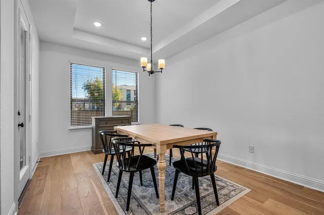 a view of a dining room with a table and chairs