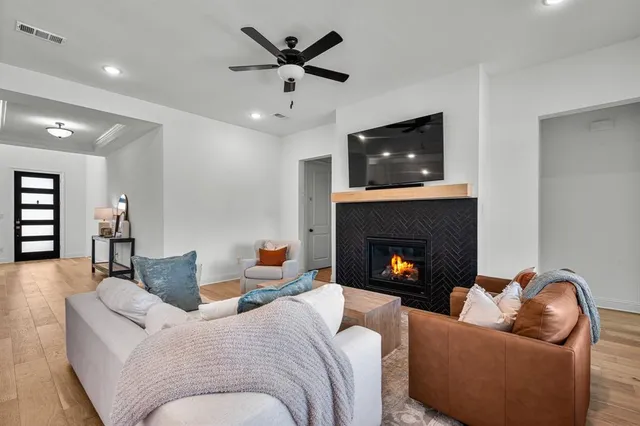 a living room with furniture and a fireplace