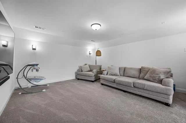 a living room with furniture a white walls and white walls