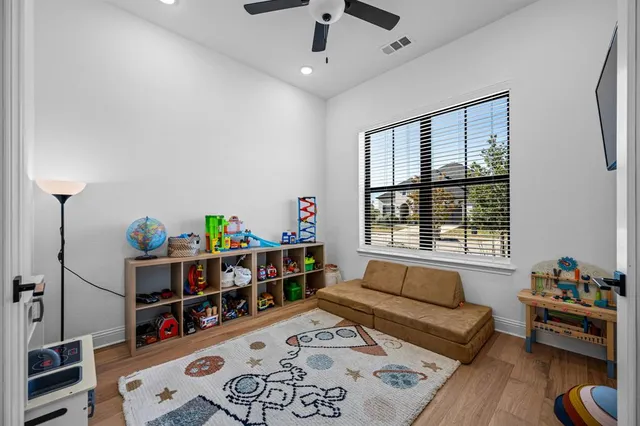 a living room with baby crib and a window