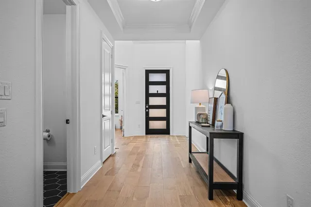 a view of a hallway with wooden floor and workspace