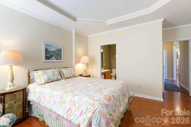 a bedroom with a bed and a night stand