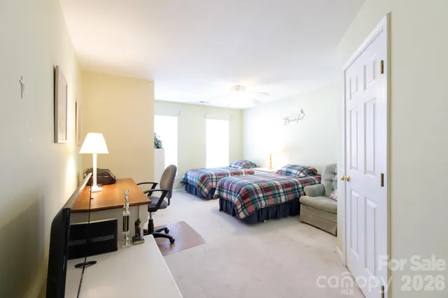 a bedroom with a bed and a lamp