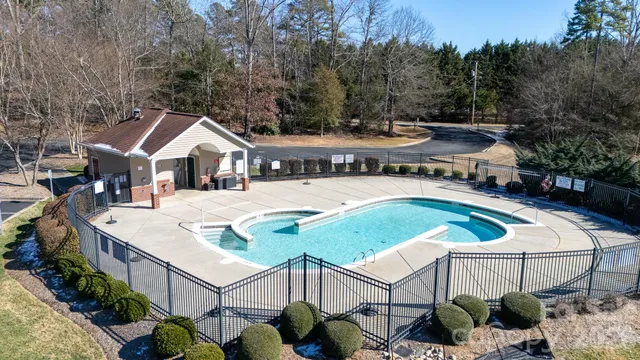an aerial view of a house with swimming pool and patio