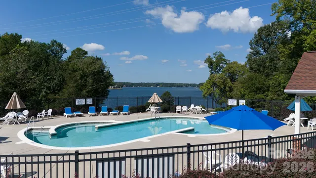 an aerial view of a house with swimming pool and garden