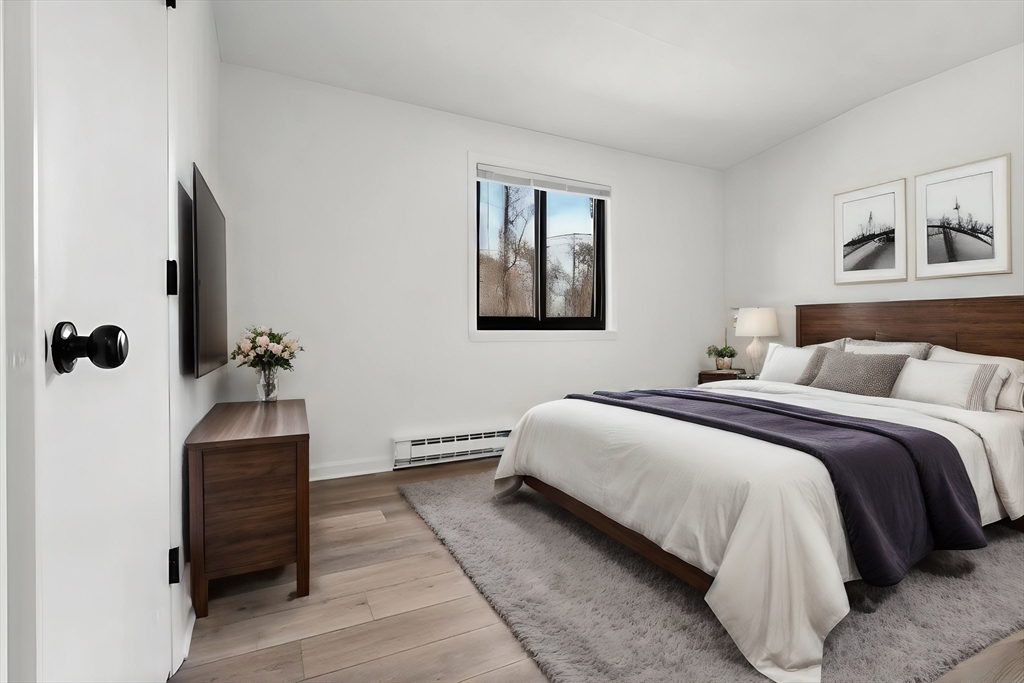 18 Pierce Street, Unit 3B Foxboro, MA 02035 - Photo 10 of 21 a bedroom with a bed and a painting on the wall