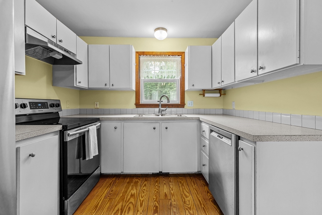 140 I Long Highway Little Compton, RI 02837 - Photo 11 of 41 a kitchen with granite countertop a sink stainless steel appliances and cabinets