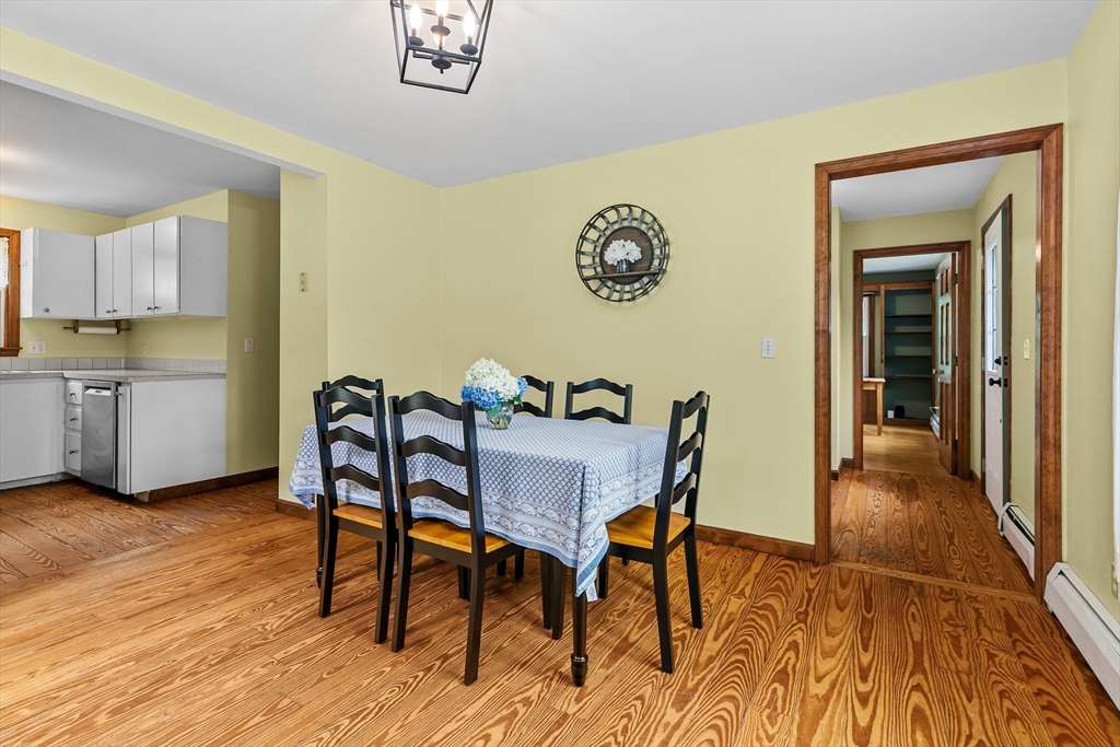 140 I Long Highway Little Compton, RI 02837 - Photo 14 of 41 a view of a dining room with furniture and wooden floor