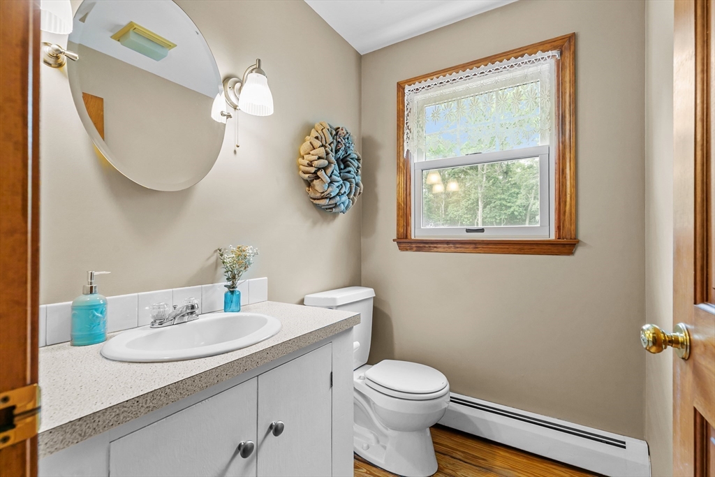 140 I Long Highway Little Compton, RI 02837 - Photo 17 of 41 a bathroom with a toilet a sink and mirror
