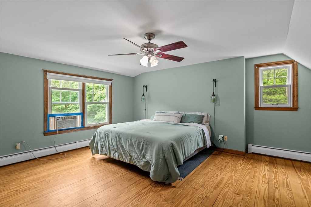 140 I Long Highway Little Compton, RI 02837 - Photo 19 of 41 a bedroom with a large bed and two windows