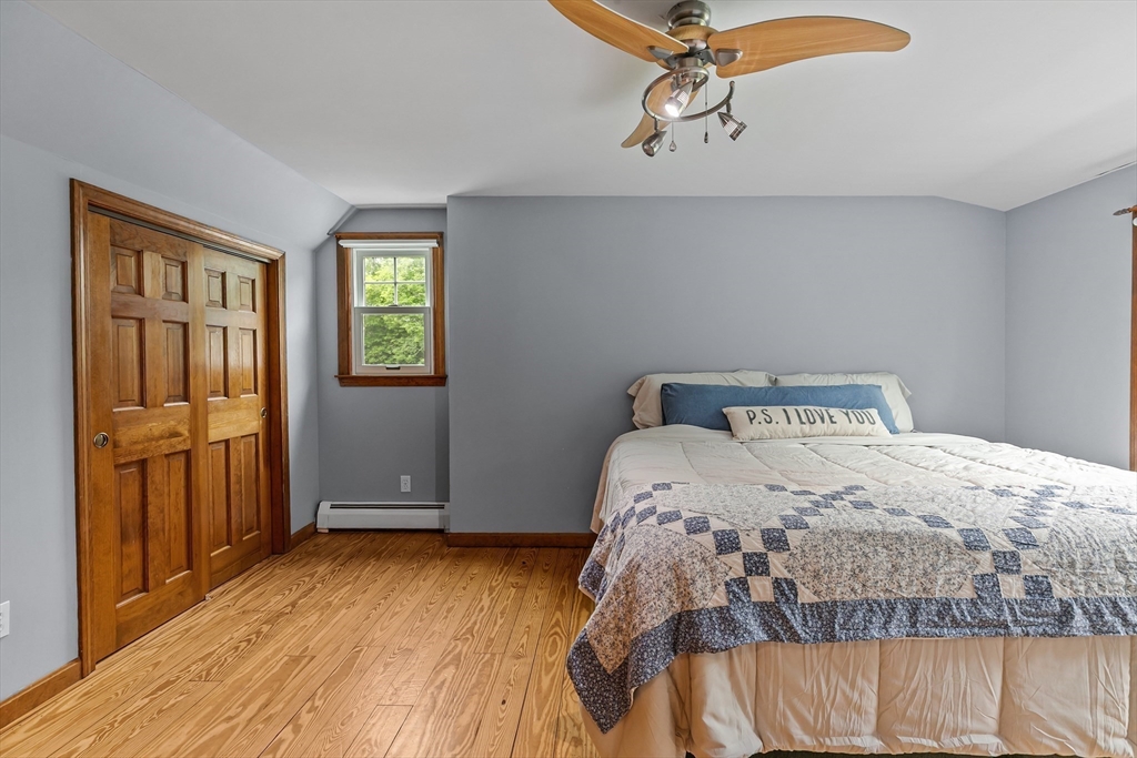 140 I Long Highway Little Compton, RI 02837 - Photo 22 of 41 a bedroom with a bed and wooden floor