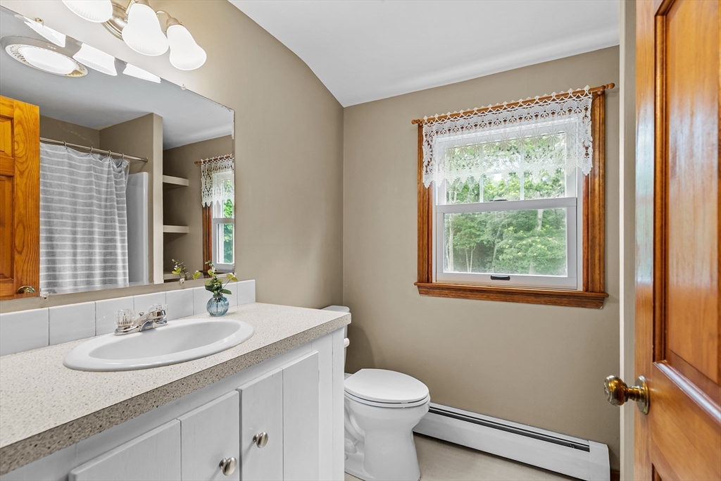 140 I Long Highway Little Compton, RI 02837 - Photo 23 of 41 a bathroom with a sink a mirror and a toilet
