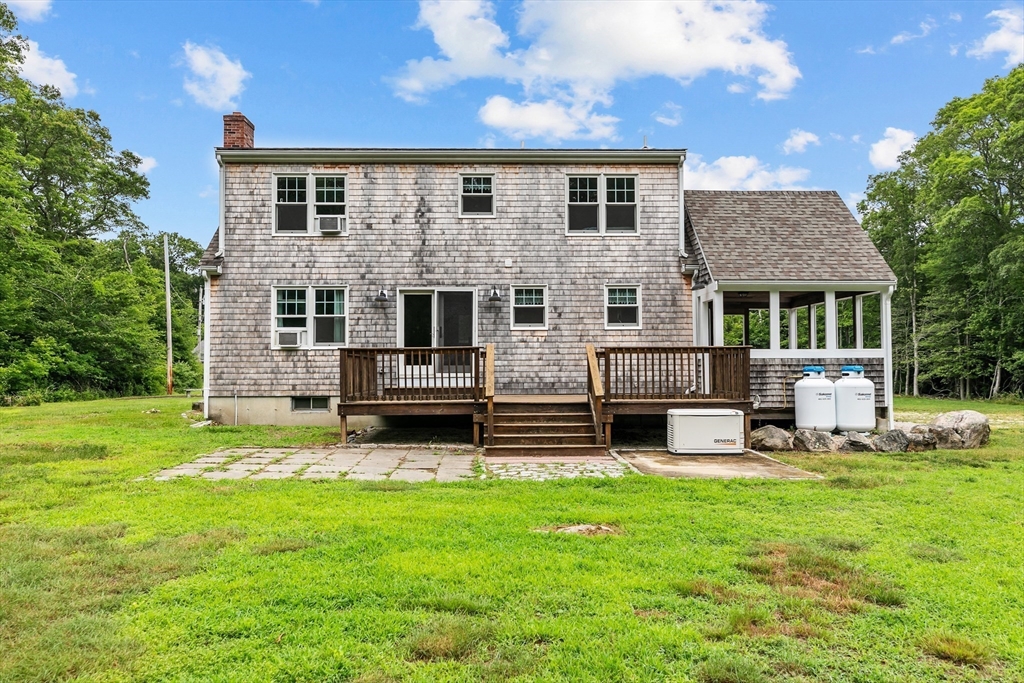 140 I Long Highway Little Compton, RI 02837 - Photo 31 of 41 a front view of a house with a yard table and chairs