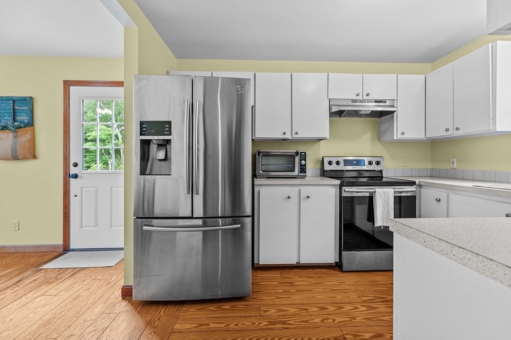 140 I Long Highway Little Compton, RI 02837 - Photo 10 of 41 a kitchen with a refrigerator sink and cabinets