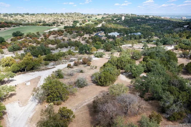 an aerial view of a houses with a yard