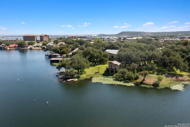 an aerial view of a houses with ocean view