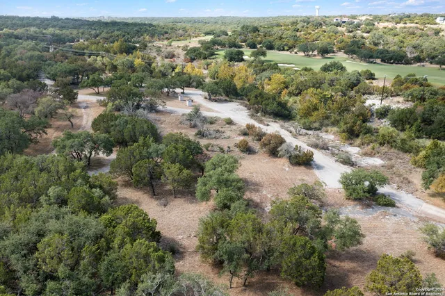 an aerial view of a houses with a yard