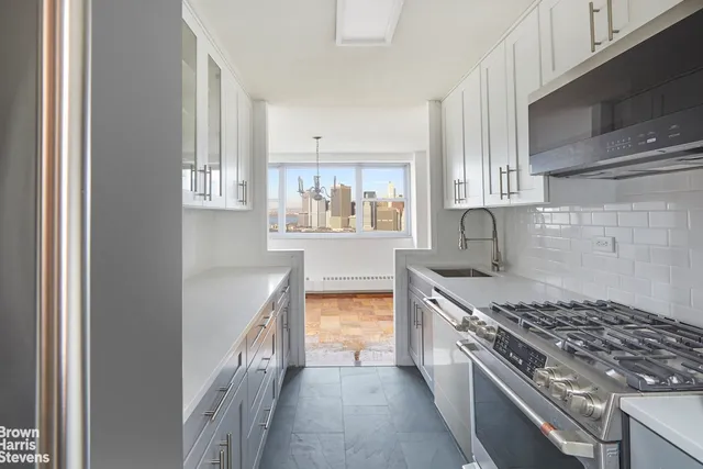 a kitchen with cabinets and a stove
