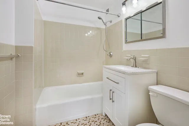 a bathroom with a sink a toilet and bathtub