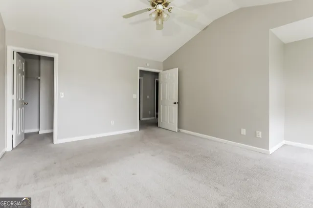 a view of an empty room with a ceiling fan