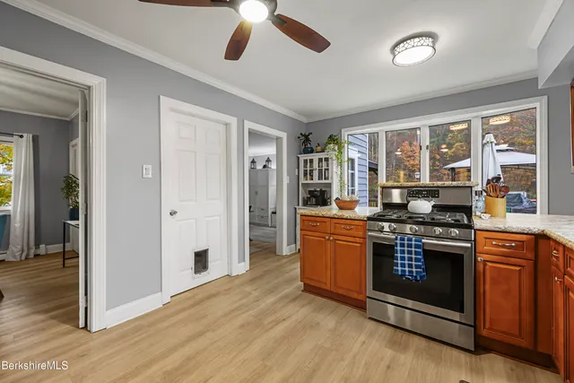a kitchen with stainless steel appliances granite countertop a stove and a refrigerator