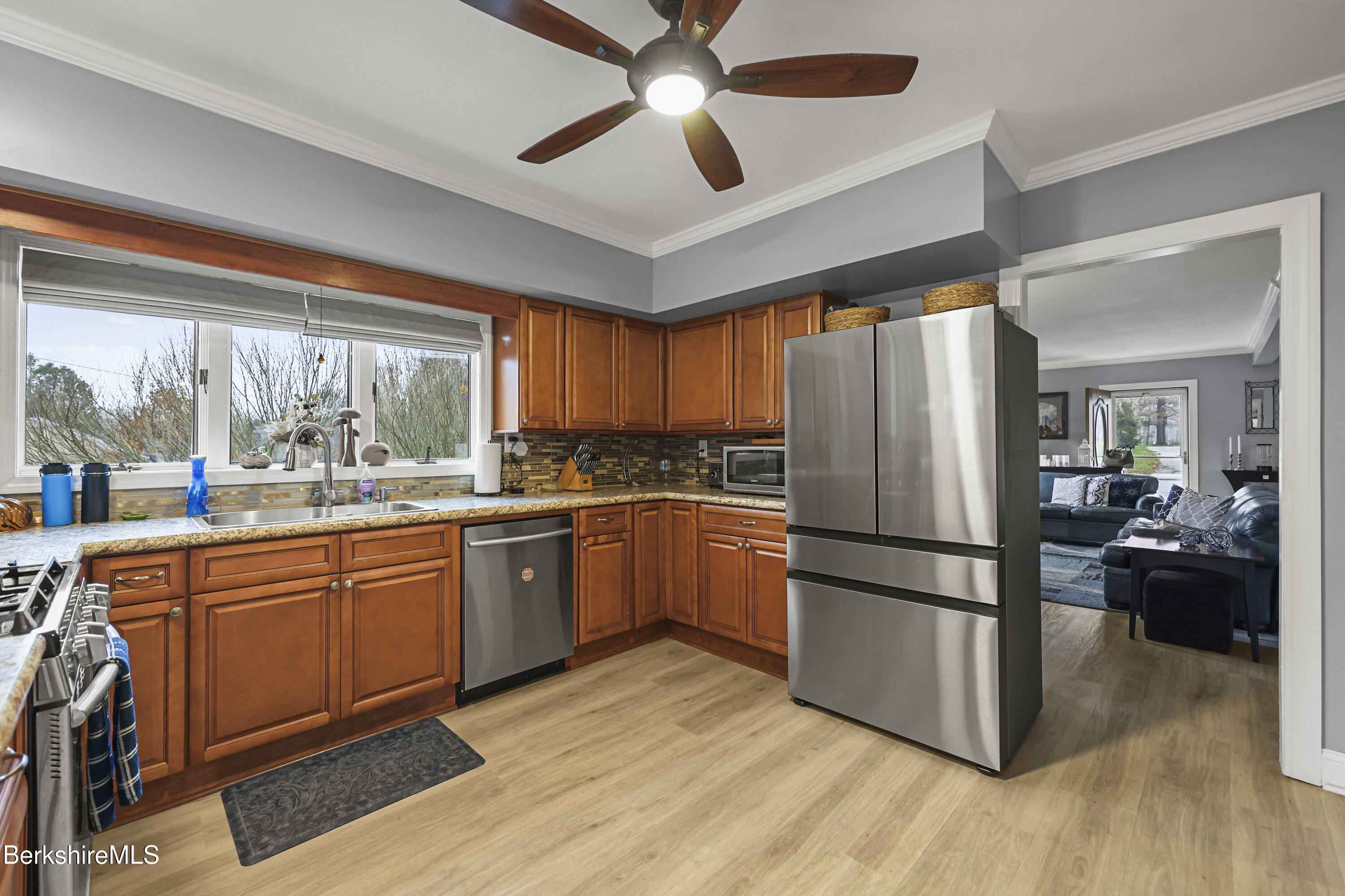386 Cheshire Road Pittsfield, MA 01201 - Photo 14 of 45 a kitchen with granite countertop appliances a sink and a large window