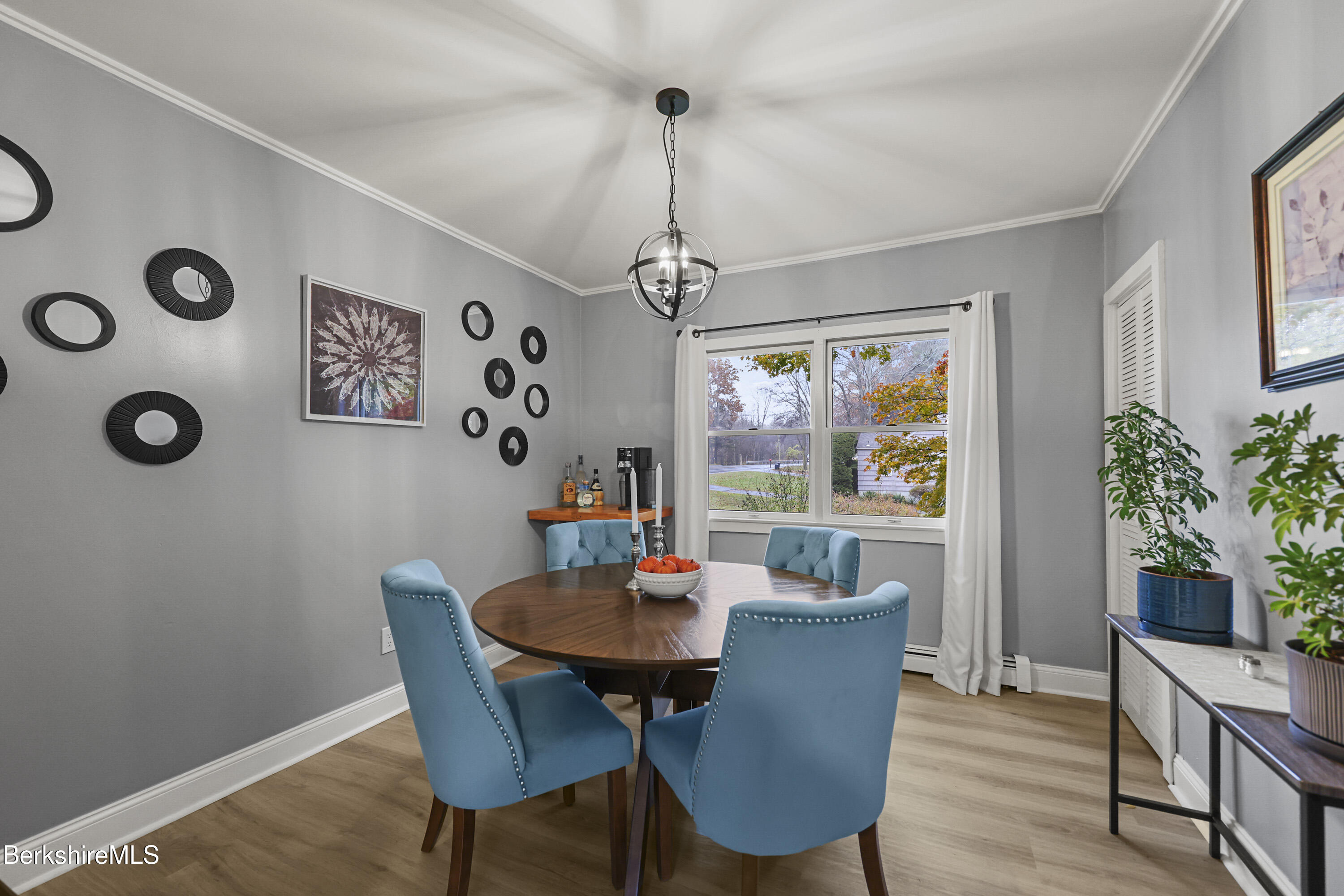 386 Cheshire Road Pittsfield, MA 01201 - Photo 15 of 45 a view of a dining room with furniture window and wooden floor