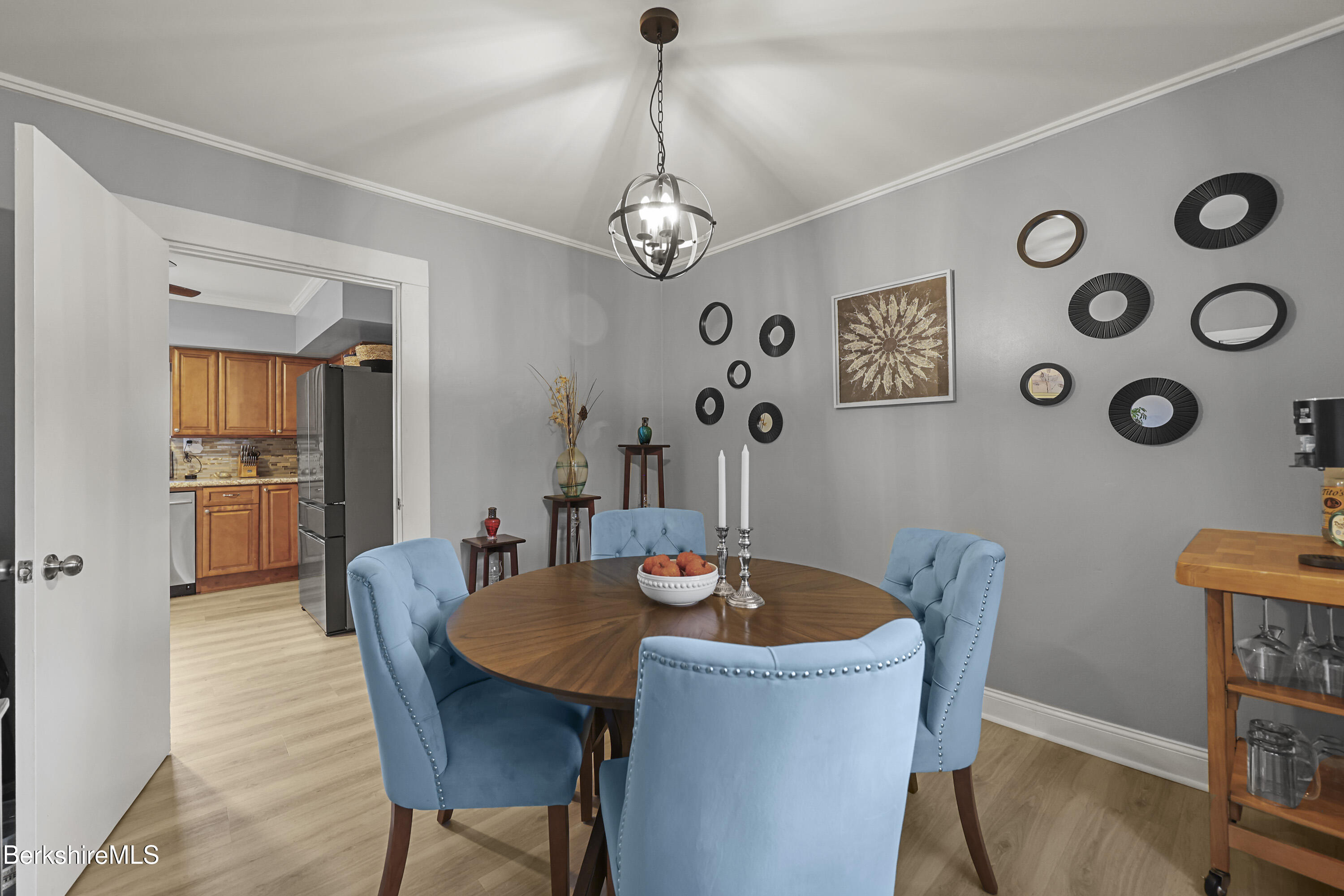 386 Cheshire Road Pittsfield, MA 01201 - Photo 16 of 45 a dining room with furniture a chandelier and wooden floor