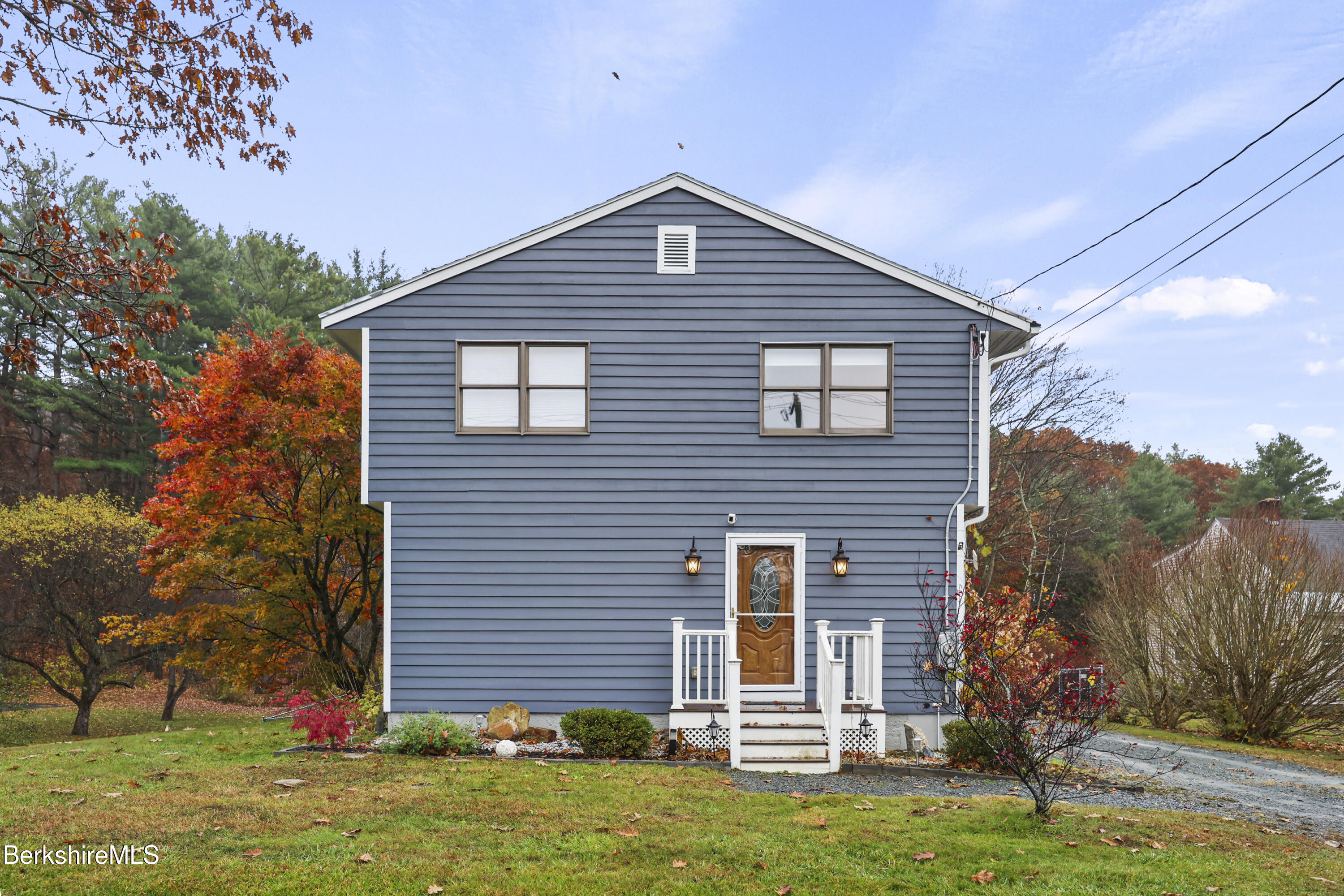 386 Cheshire Road Pittsfield, MA 01201 - Photo 2 of 45 a front view of a house with a yard
