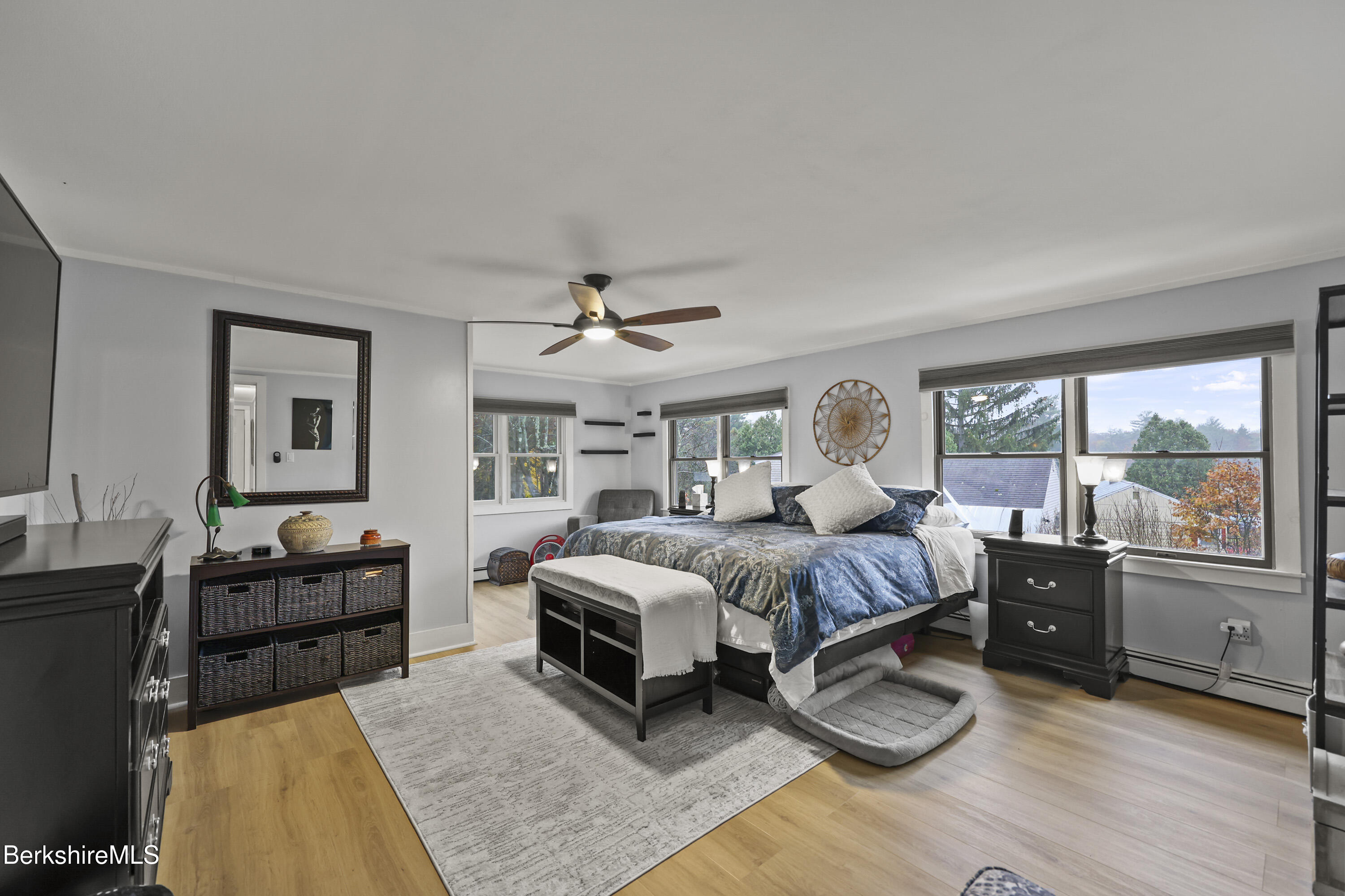 386 Cheshire Road Pittsfield, MA 01201 - Photo 24 of 45 a spacious bedroom with a bed and wooden floor