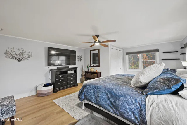 a bedroom with a bed and a flat screen tv