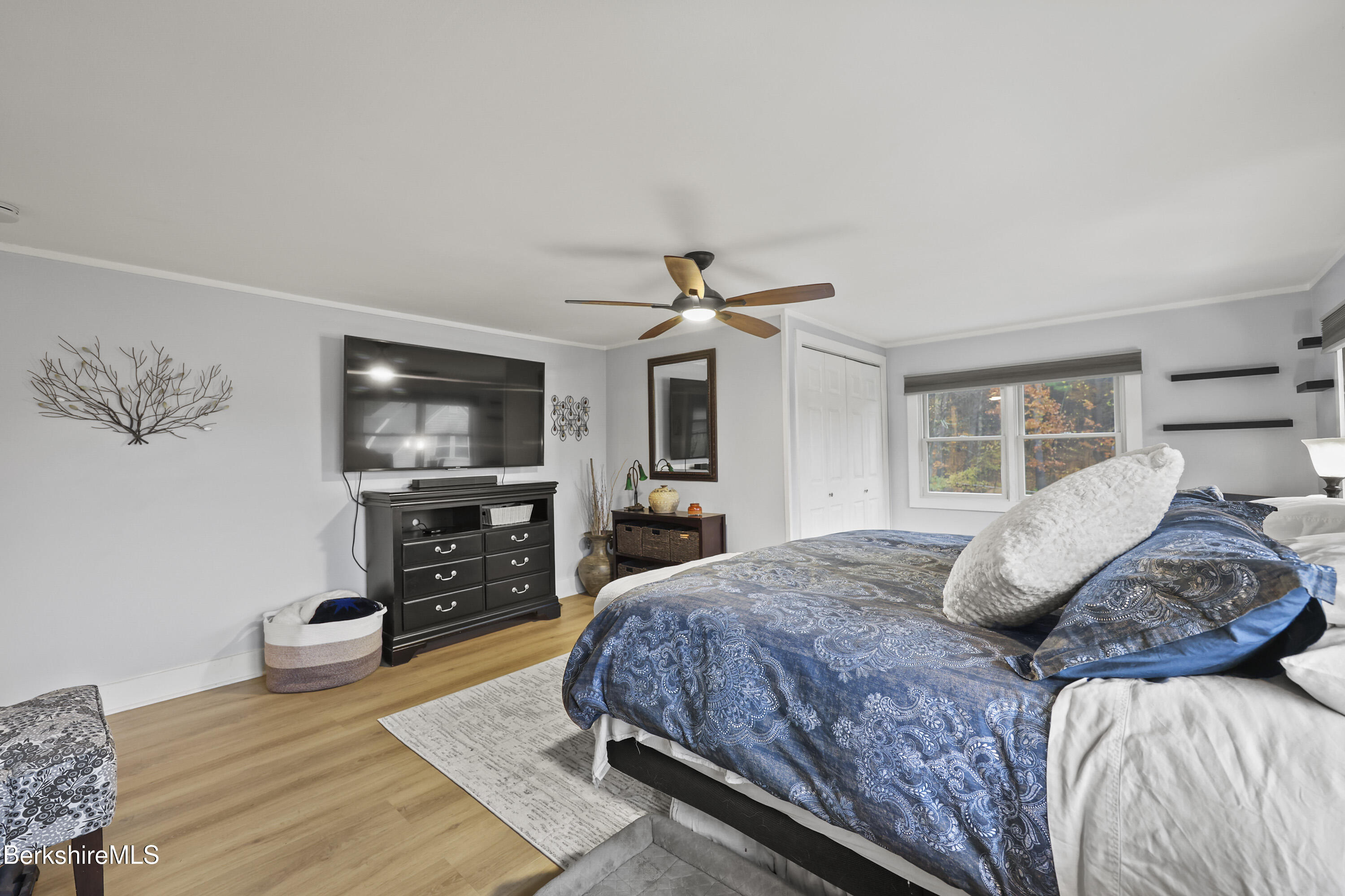 386 Cheshire Road Pittsfield, MA 01201 - Photo 25 of 45 a bedroom with a bed and a flat screen tv