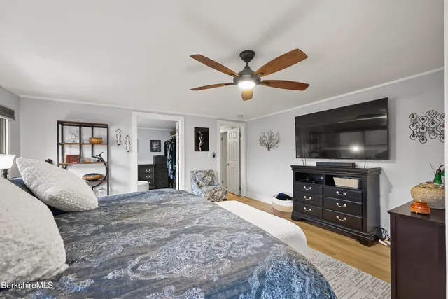 a bedroom with a bed and a flat screen tv