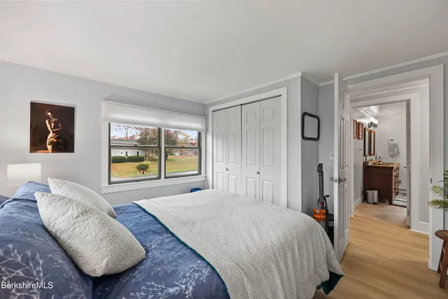 a spacious bedroom with a bed and a large window