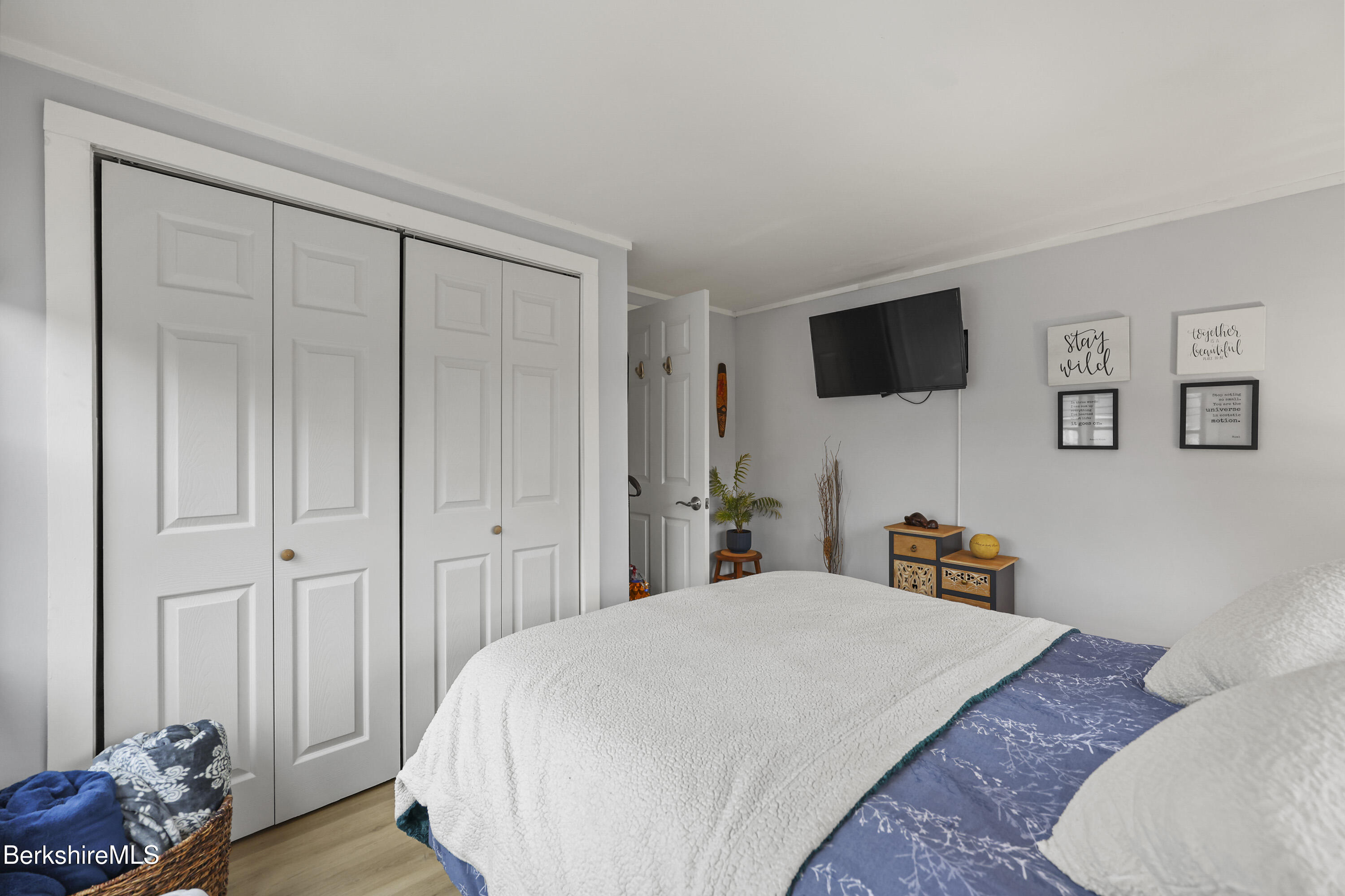 386 Cheshire Road Pittsfield, MA 01201 - Photo 31 of 45 a spacious bedroom with a bed and a flat screen tv