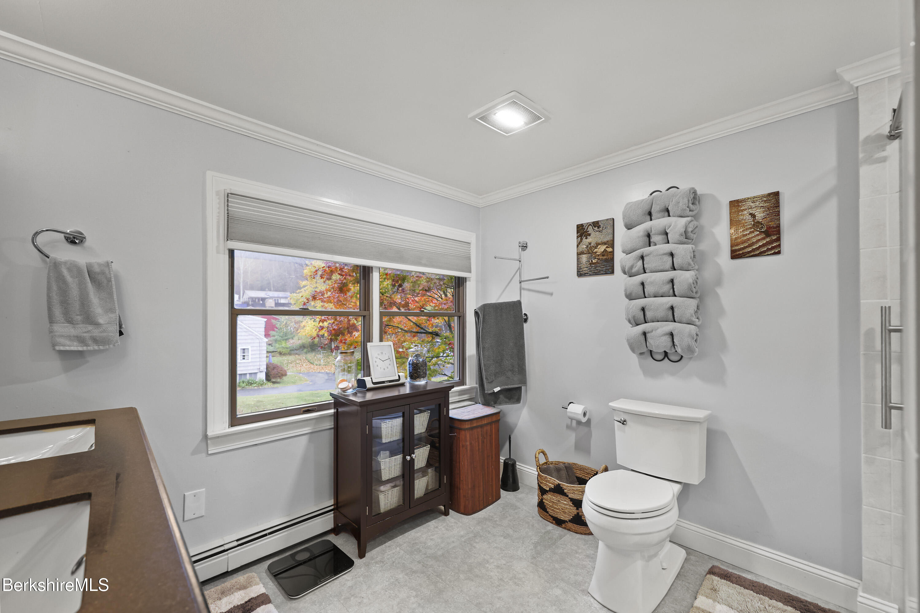 386 Cheshire Road Pittsfield, MA 01201 - Photo 35 of 45 a bathroom with a toilet a sink and a window