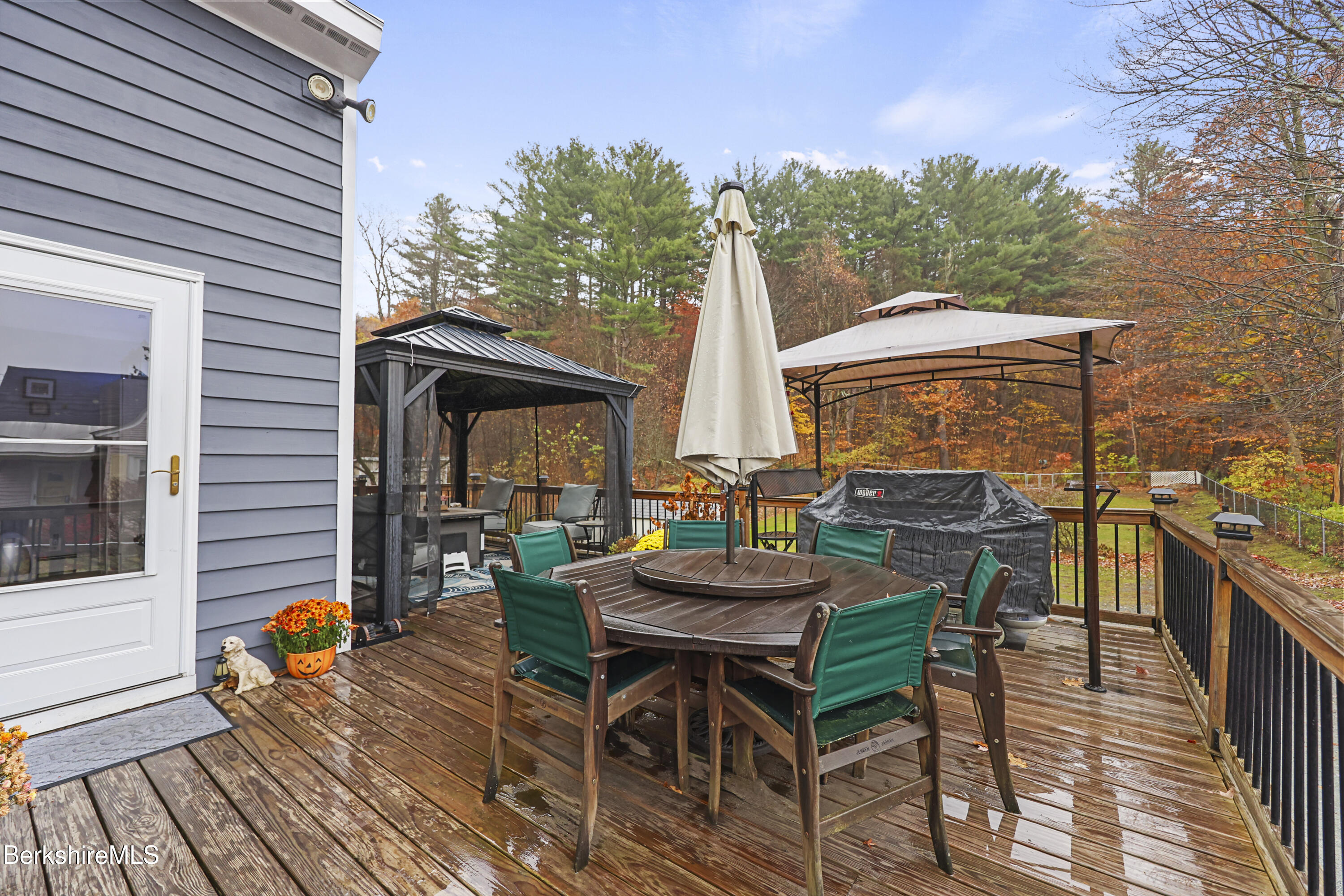 386 Cheshire Road Pittsfield, MA 01201 - Photo 38 of 45 a view of a patio with table and chairs and potted plants