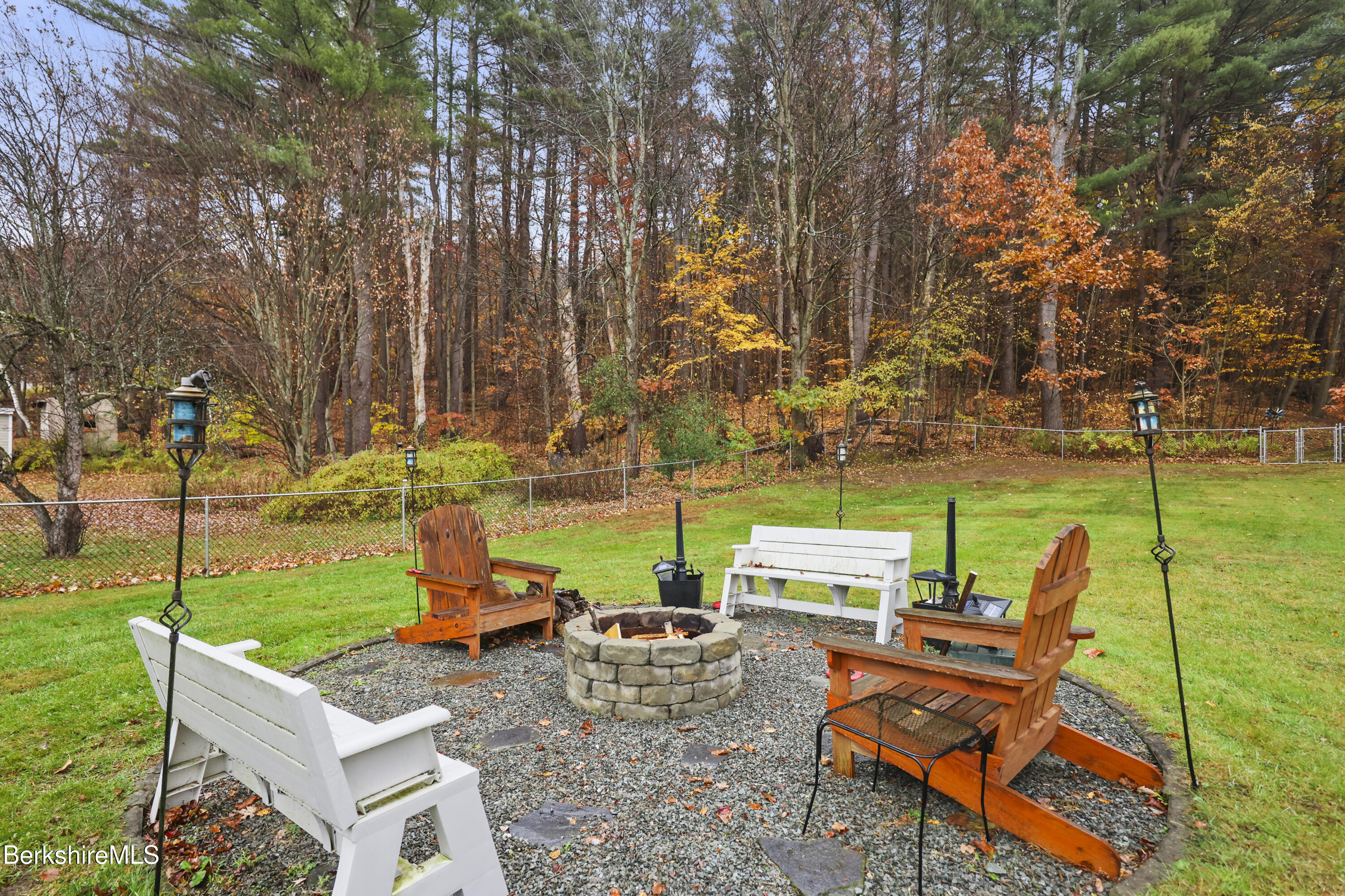 386 Cheshire Road Pittsfield, MA 01201 - Photo 4 of 45 a view of backyard with seating area and trees