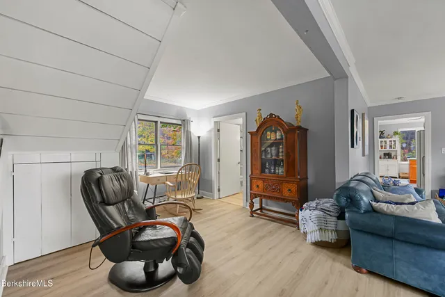 a living room with furniture and a mirror