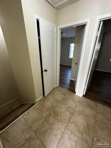 an empty room with mirror and stairs