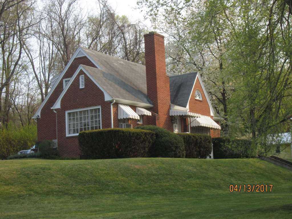 1917 Shutterlee Mill Road Staunton, VA 24401 - Photo 1 of 40 a front view of a house with a garden