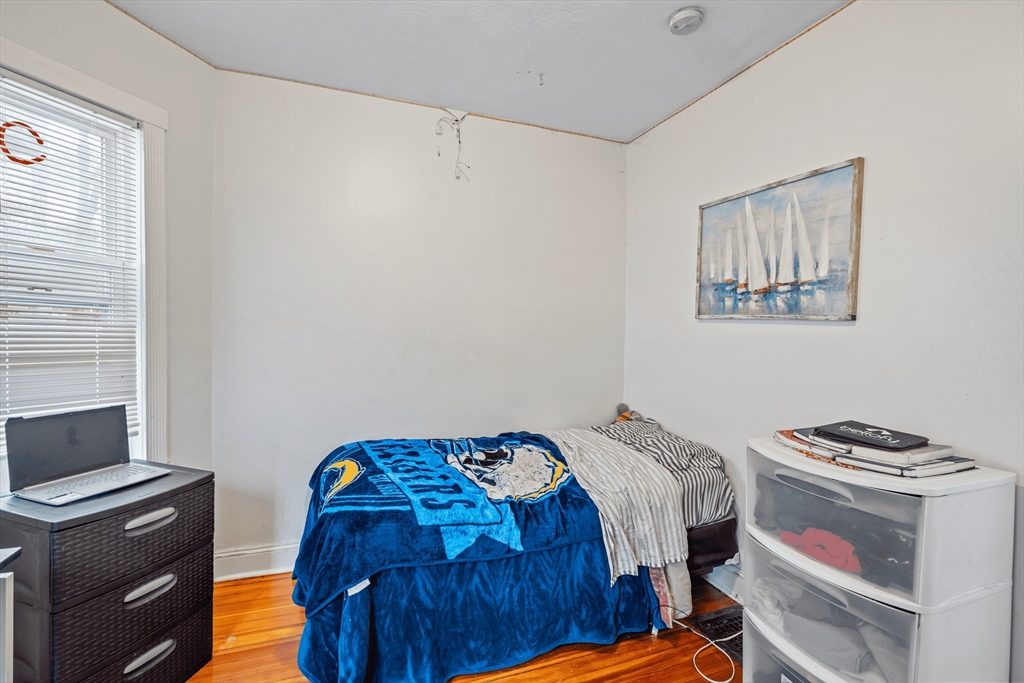 385 Centre Street, Unit 1 Boston, MA 02122 - Photo 11 of 14 a bedroom with a bed and a window