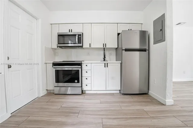 a kitchen with a refrigerator and a stove