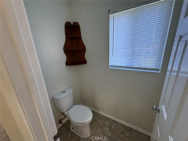 a view of a street with a house in the background