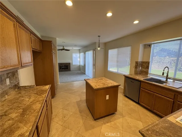 a large kitchen with kitchen island a sink stainless steel appliances and cabinets