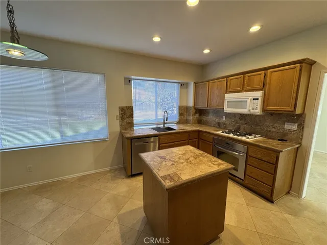 a kitchen with a sink a counter top space and appliances
