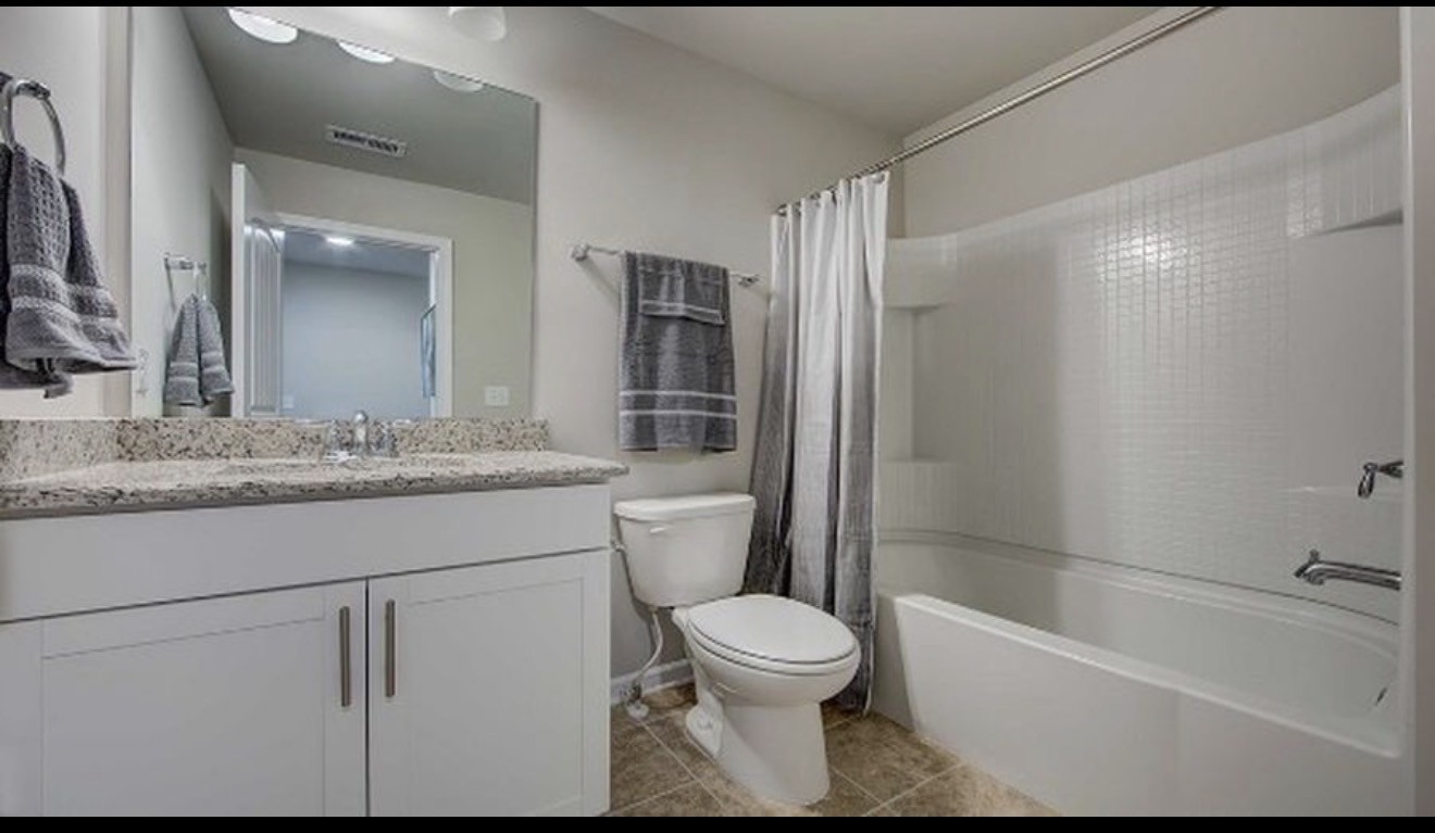4107 Grapevine Loop Smyrna, TN 37167 - Photo 7 of 12 a bathroom with a granite countertop sink toilet and shower