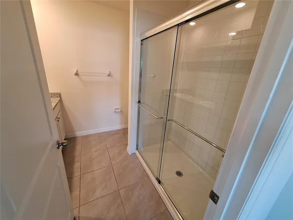 a bathroom with a glass door shower