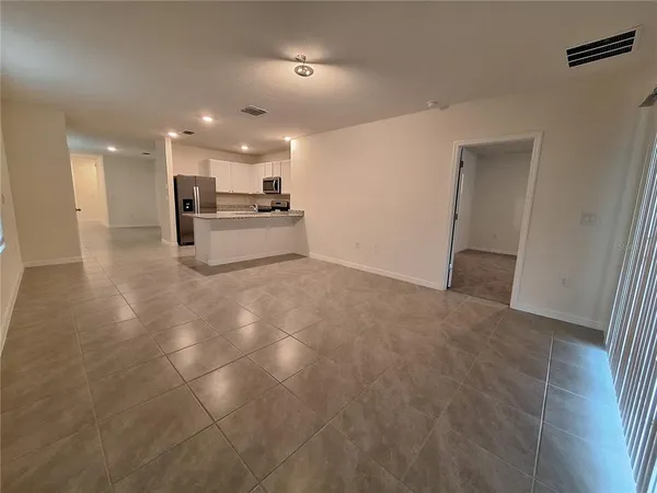 a view of kitchen with kitchen island white cabinets and appliances