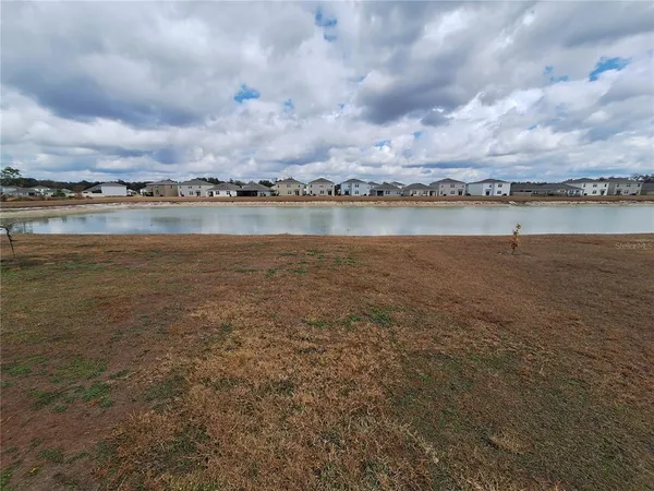 a view of a lake with houses in the back